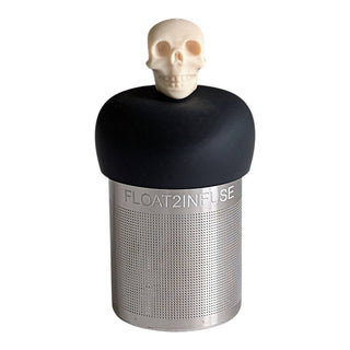 Skull-shaped infuser with black top and metal mesh body on a white background
