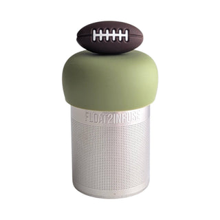 A cylindrical portable speaker with a metallic silver perforated body, an olive green top section, and a small brown football-shaped accent on top, shown on a plain white background.