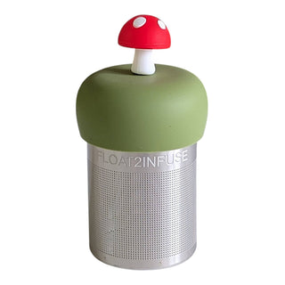 Green container with red mushroom-shaped lid on a white background